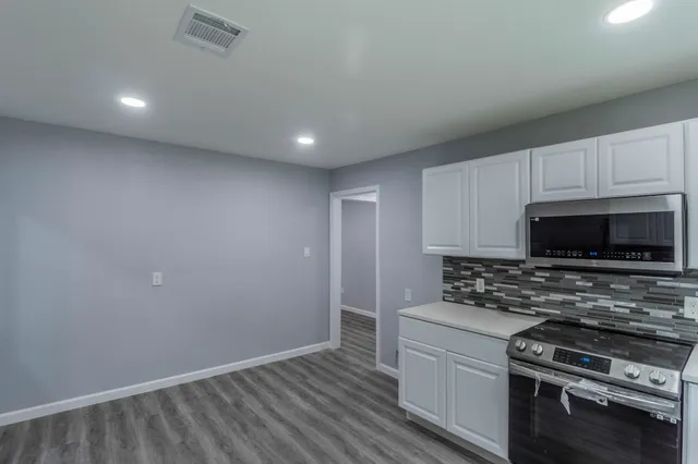 a kitchen with wooden cabinets and a stove top oven