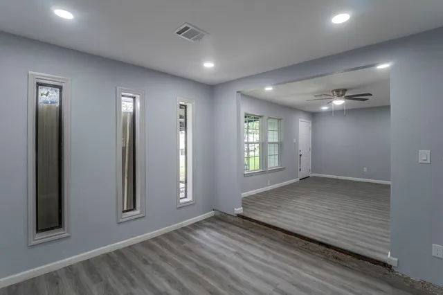 an empty room with windows and closet