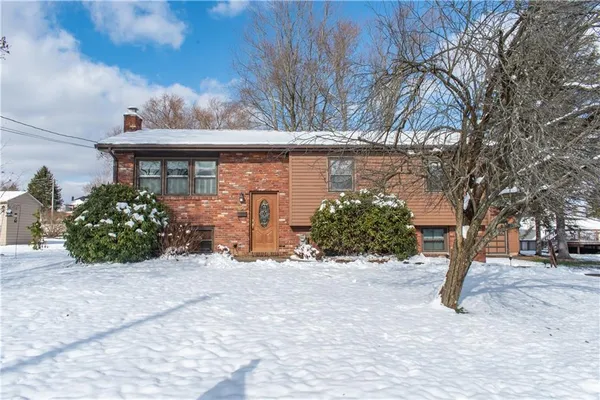 a view of a house with a yard and garage