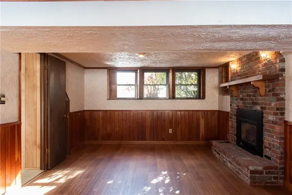 a view of wooden floor and a fireplace in a room