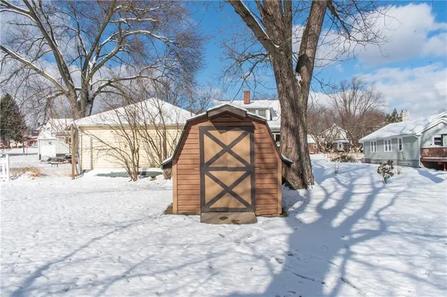 a front view of a house with a yard covered with snow in front of house