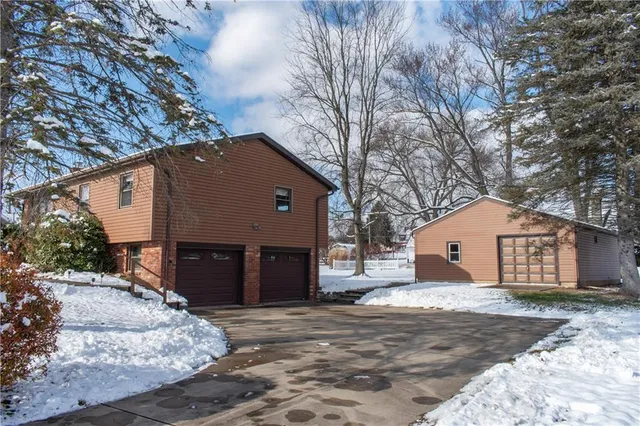 a view of a house with a yard covered in snow