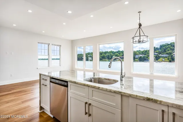 a kitchen with granite countertop a sink and a window