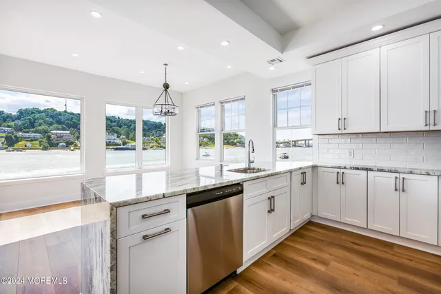 a kitchen with a sink window and cabinets