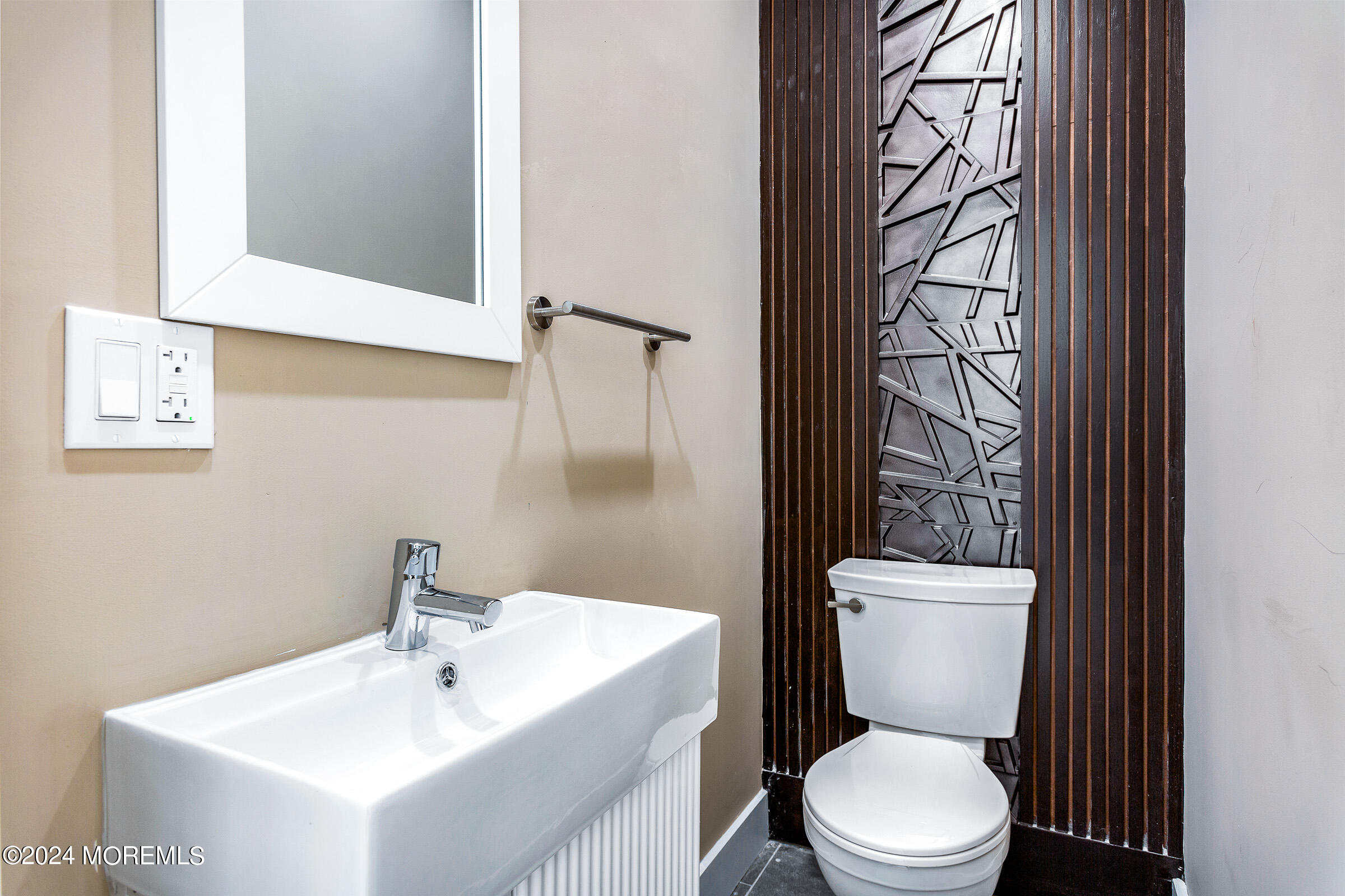 10 Via Ripa Way, Unit 2 Sea Bright, NJ 07760 - Photo 16 of 44 a white toilet sitting next to a bathroom sink