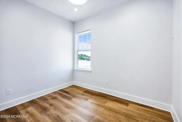 a view of a room with wooden floor and natural light