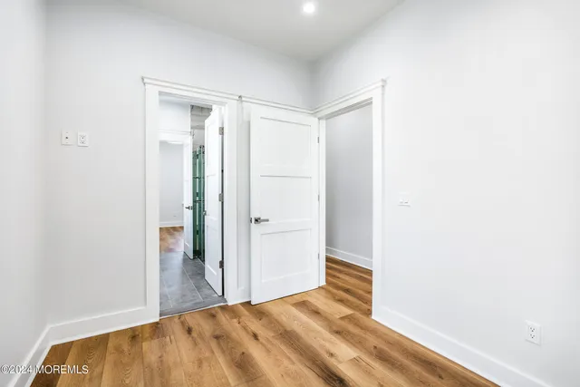 a view of a room with wooden floor