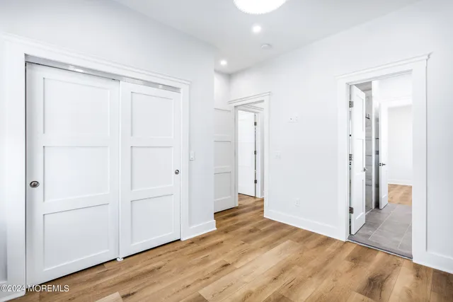 a view of empty room with wooden floor