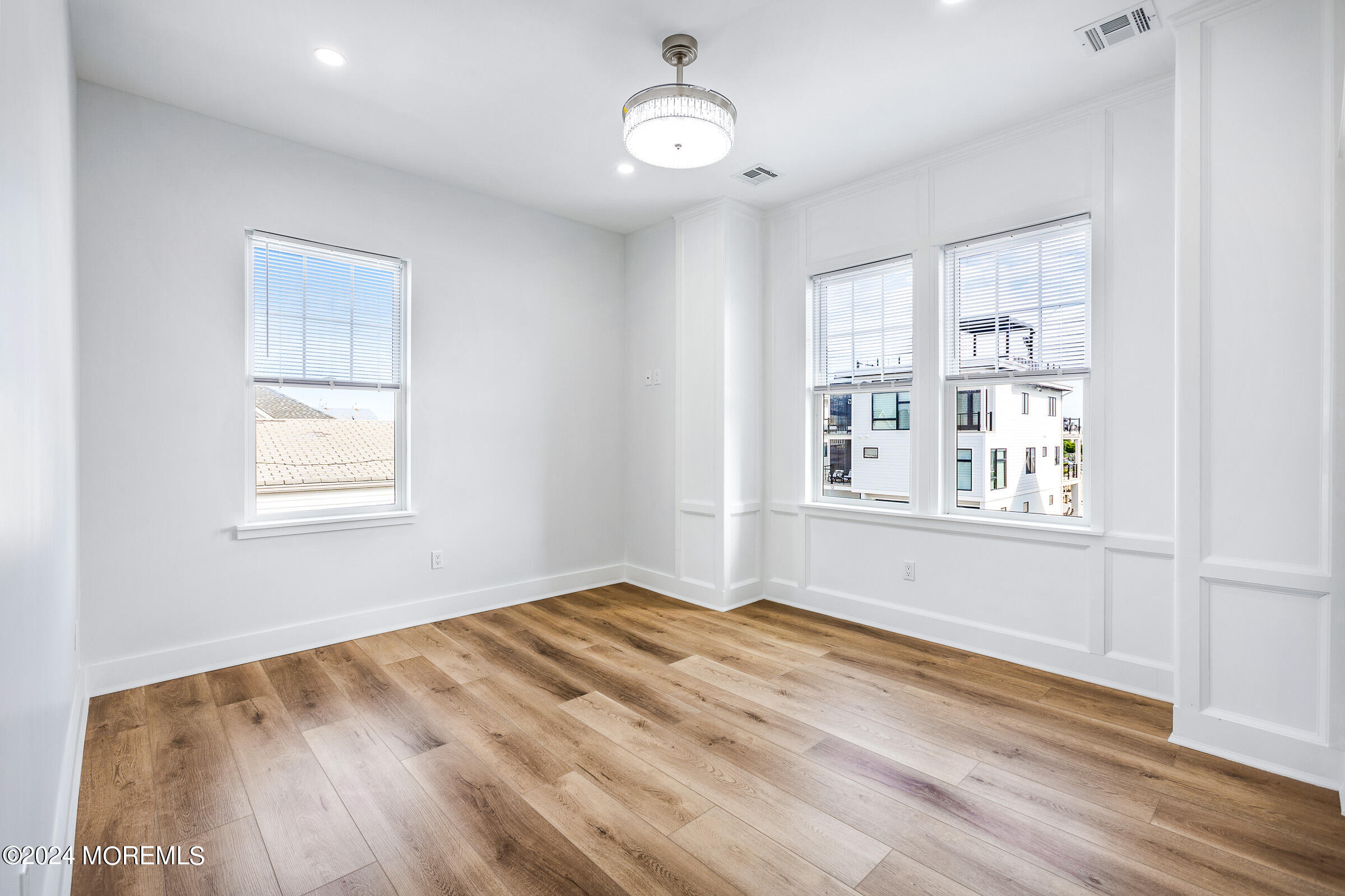 10 Via Ripa Way, Unit 2 Sea Bright, NJ 07760 - Photo 23 of 44 a view of an empty room with wooden floor and a window