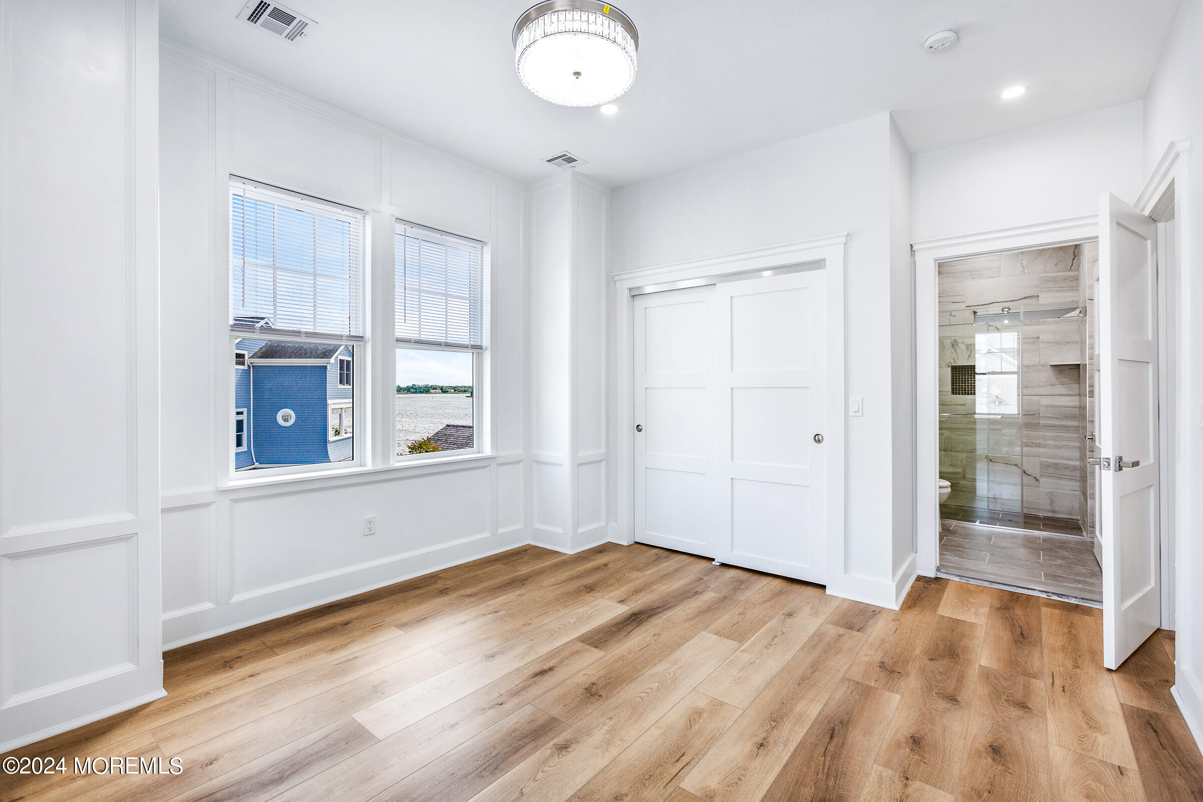 10 Via Ripa Way, Unit 2 Sea Bright, NJ 07760 - Photo 24 of 44 a view of empty room with wooden floor and fan