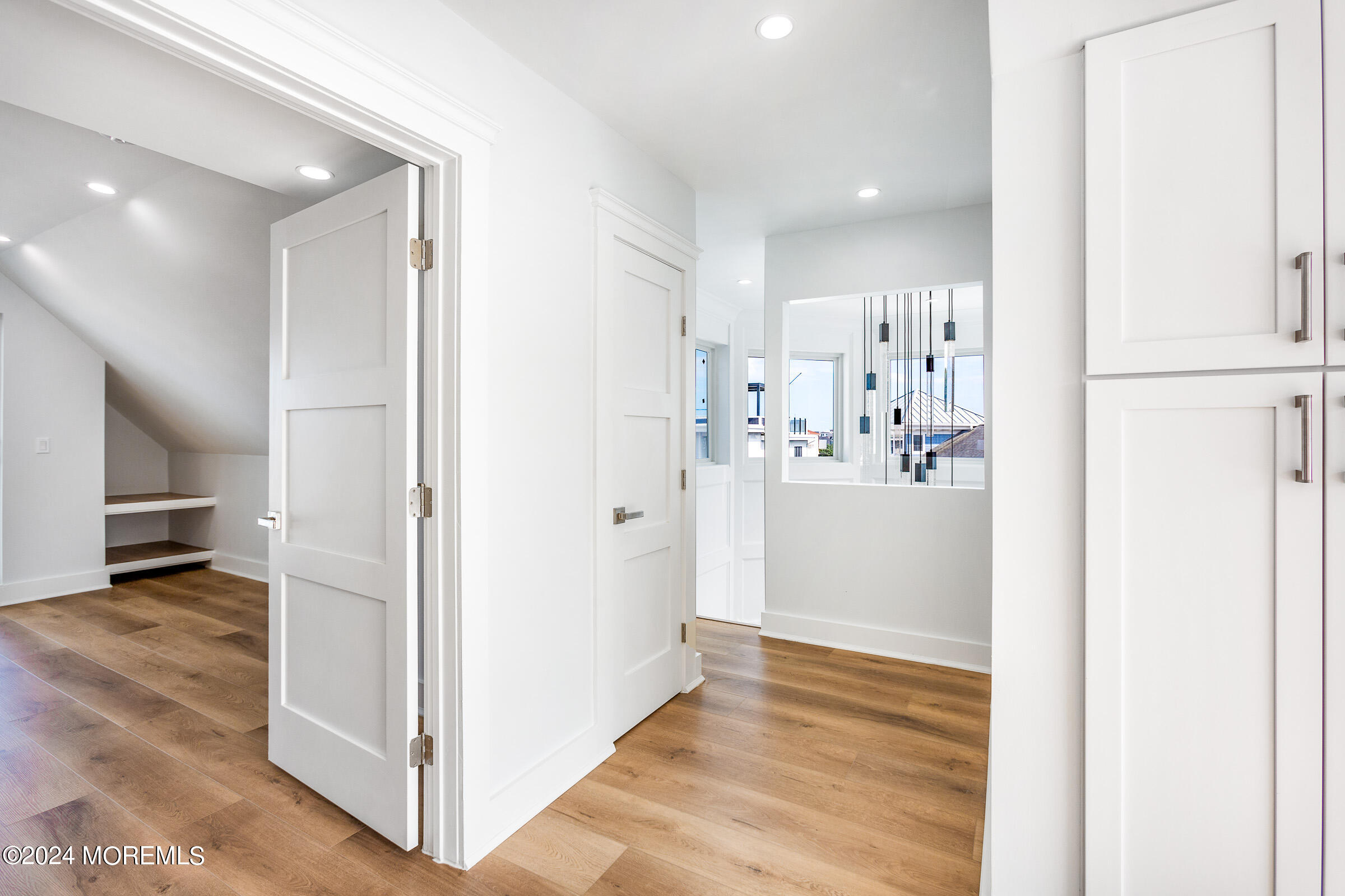 10 Via Ripa Way, Unit 2 Sea Bright, NJ 07760 - Photo 30 of 44 a view of a kitchen and a hallway with wooden floor