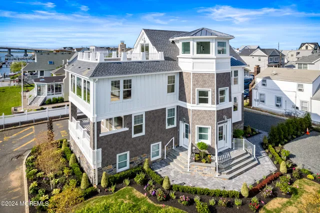 a front view of a building with a garden