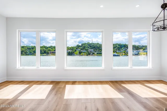 a view of an empty room with a window and tub