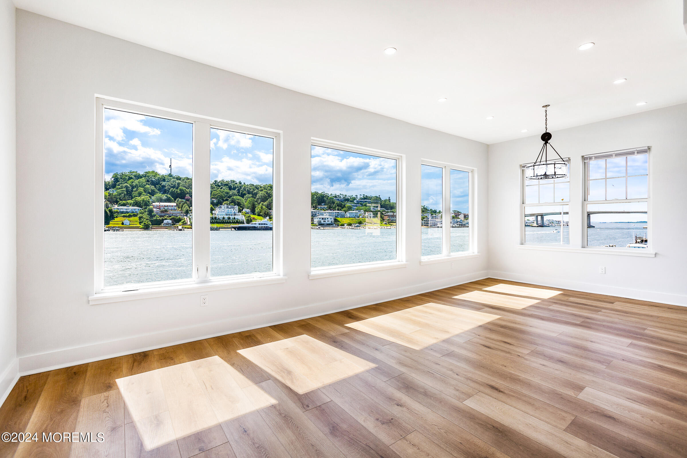 10 Via Ripa Way, Unit 2 Sea Bright, NJ 07760 - Photo 7 of 44 a view of an empty room with wooden floor and a window