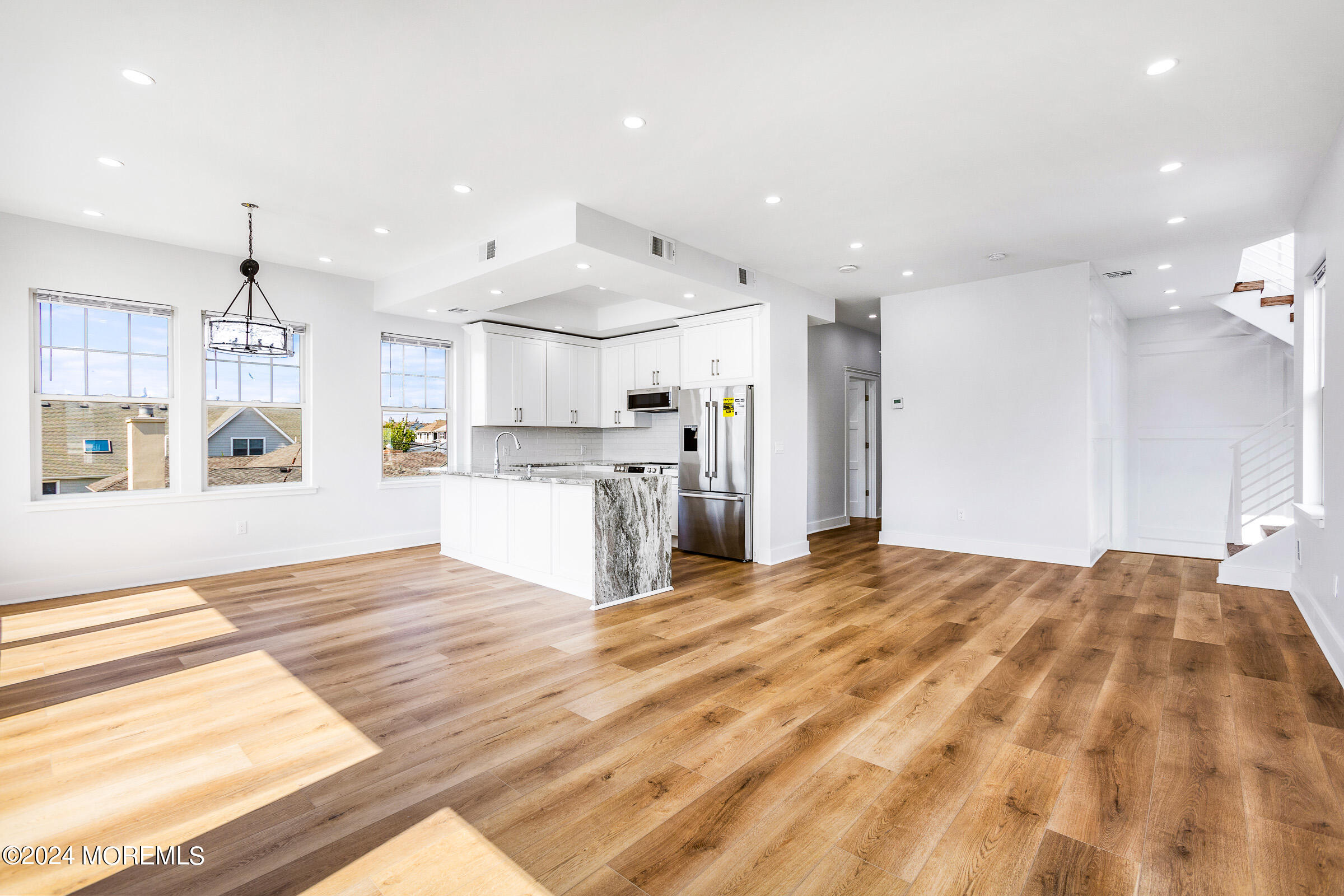 10 Via Ripa Way, Unit 2 Sea Bright, NJ 07760 - Photo 9 of 44 a large kitchen with kitchen island a sink stainless steel appliances and cabinets