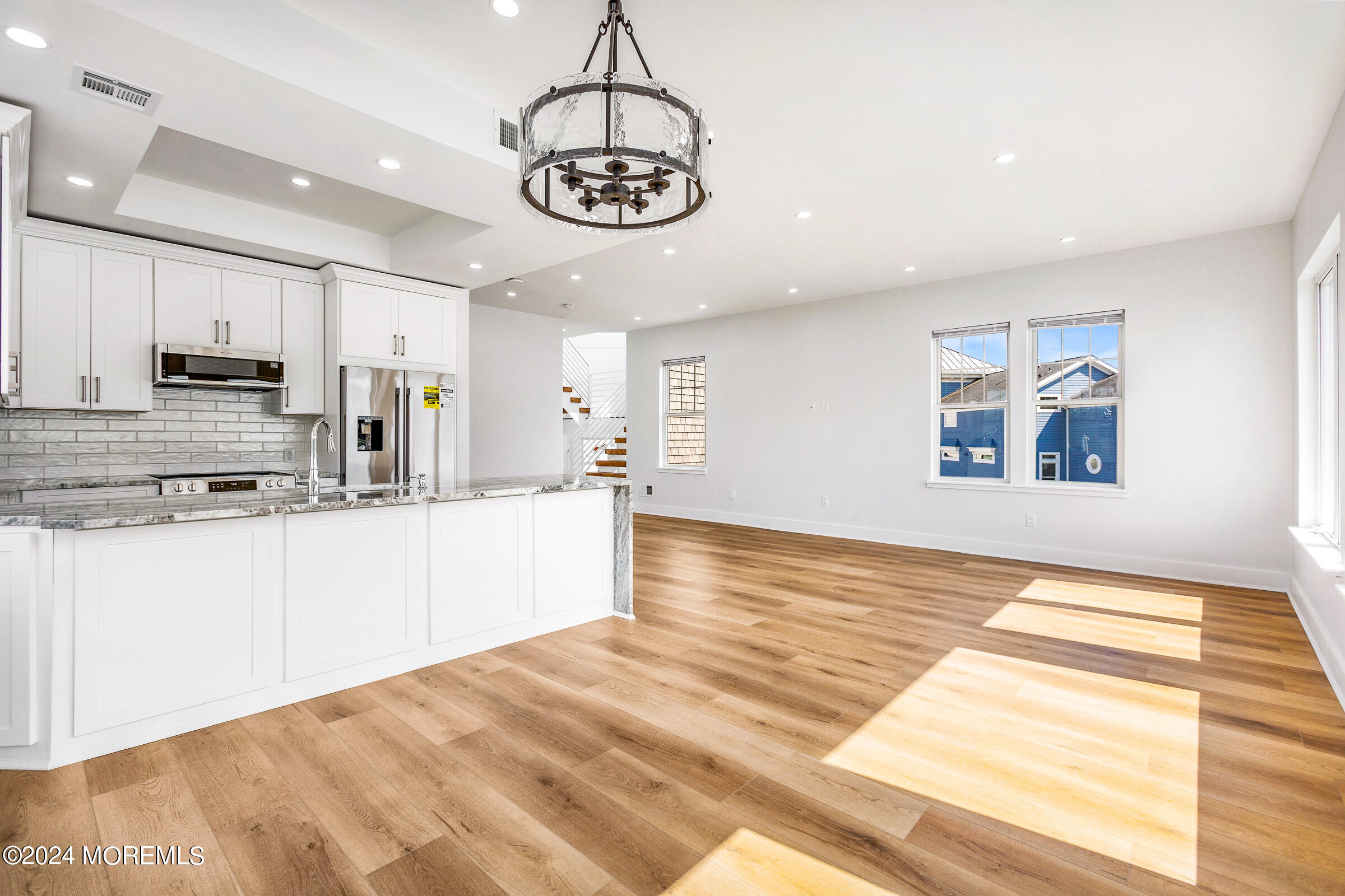 10 Via Ripa Way, Unit 2 Sea Bright, NJ 07760 - Photo 10 of 44 a view of a kitchen with stainless steel appliances granite countertop a stove a sink dishwasher and white cabinets with wooden floor