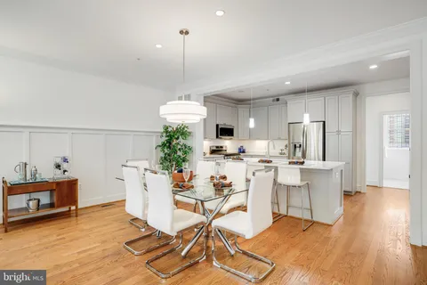 a view of a dining room with furniture wooden floor and a chandelier