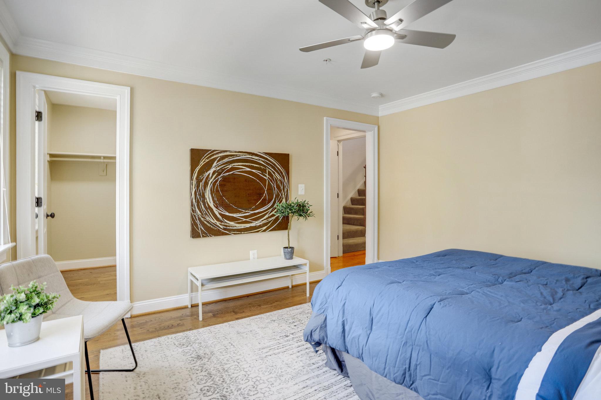 8920 Courts Way Silver Spring, MD 20910 - Photo 31 of 52 a bedroom with a bed and a chandelier