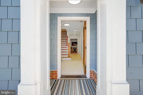 a view of a hallway view with wooden floor and staircase