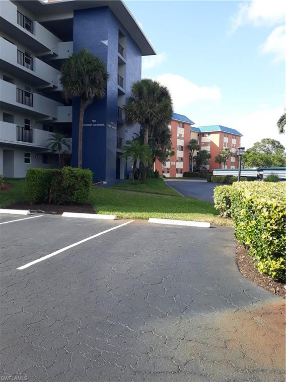 190 Pebble Beach Boulevard, Unit 503 Naples, FL 34113 - Photo 13 of 17 a view of a house with a yard and garage