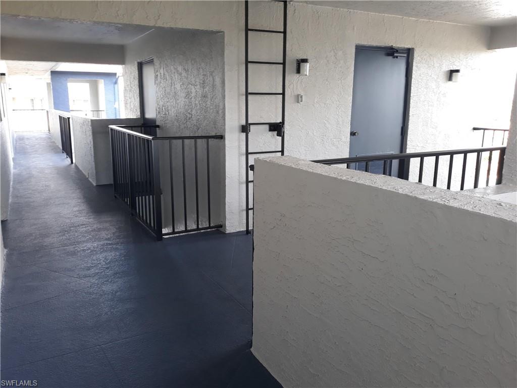 190 Pebble Beach Boulevard, Unit 503 Naples, FL 34113 - Photo 15 of 17 a view of a hallway with windows