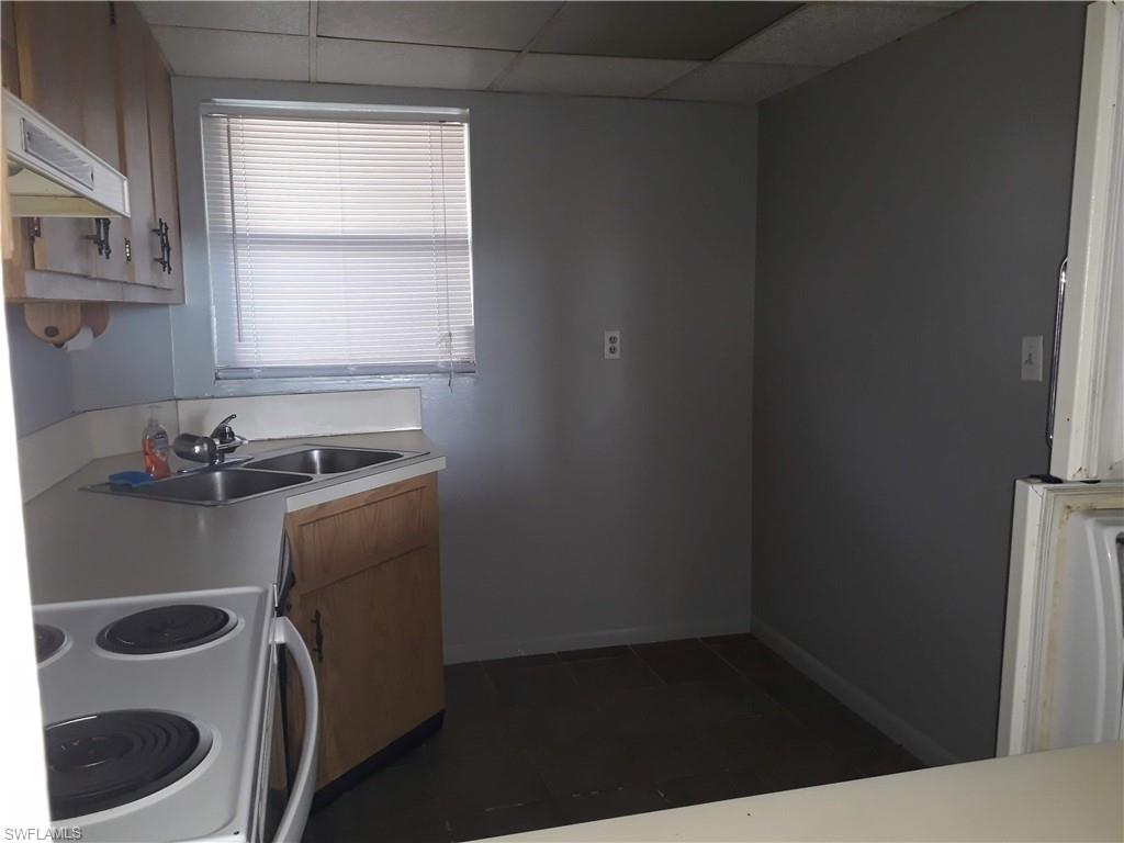 190 Pebble Beach Boulevard, Unit 503 Naples, FL 34113 - Photo 3 of 17 a room with a sink a washer and dryer