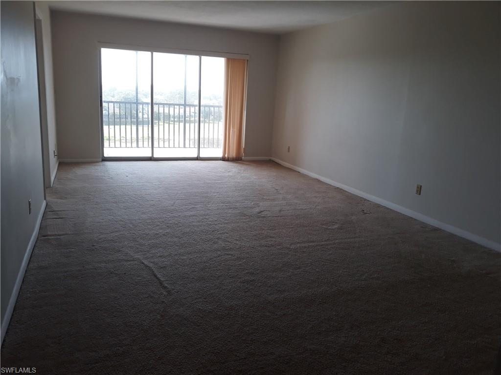 190 Pebble Beach Boulevard, Unit 503 Naples, FL 34113 - Photo 5 of 17 a view of an empty room with a window