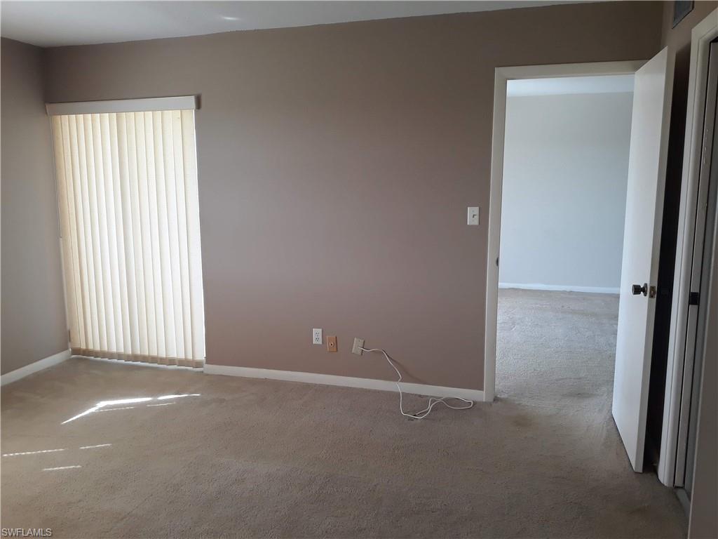 190 Pebble Beach Boulevard, Unit 503 Naples, FL 34113 - Photo 6 of 17 an empty room with windows