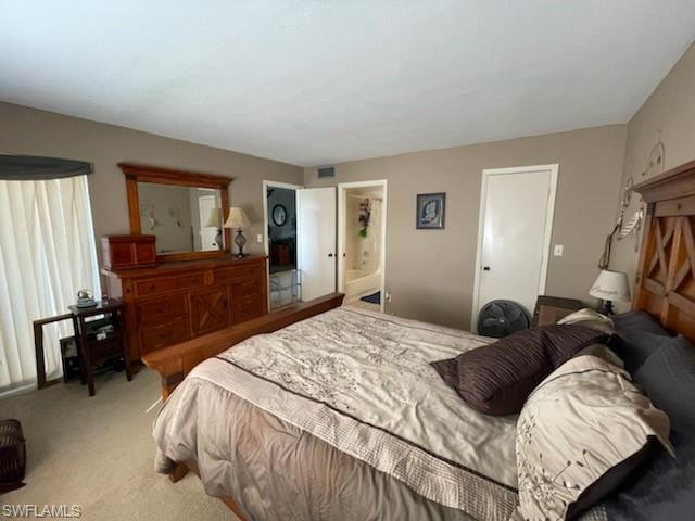 190 Pebble Beach Boulevard, Unit 503 Naples, FL 34113 - Photo 7 of 17 a bedroom with a bed and a dresser