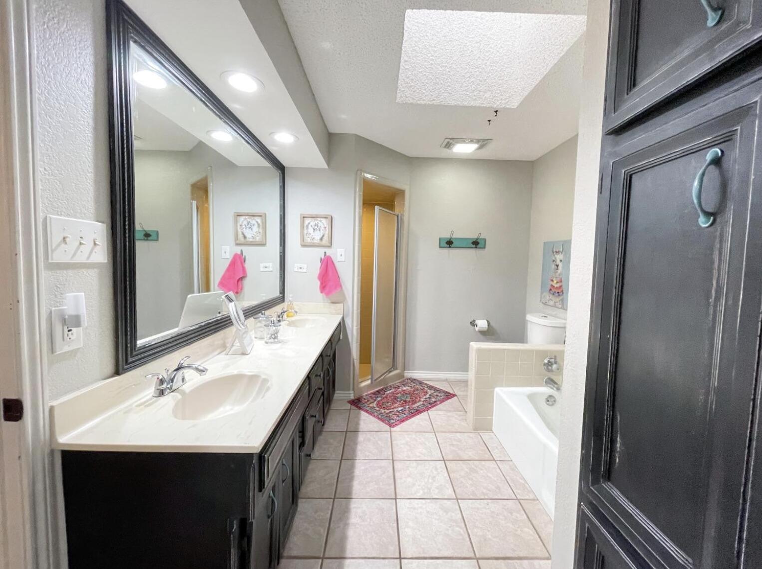5413 83rd Street Lubbock, TX 79424 - Photo 12 of 21 a bathroom with a sink and a mirror