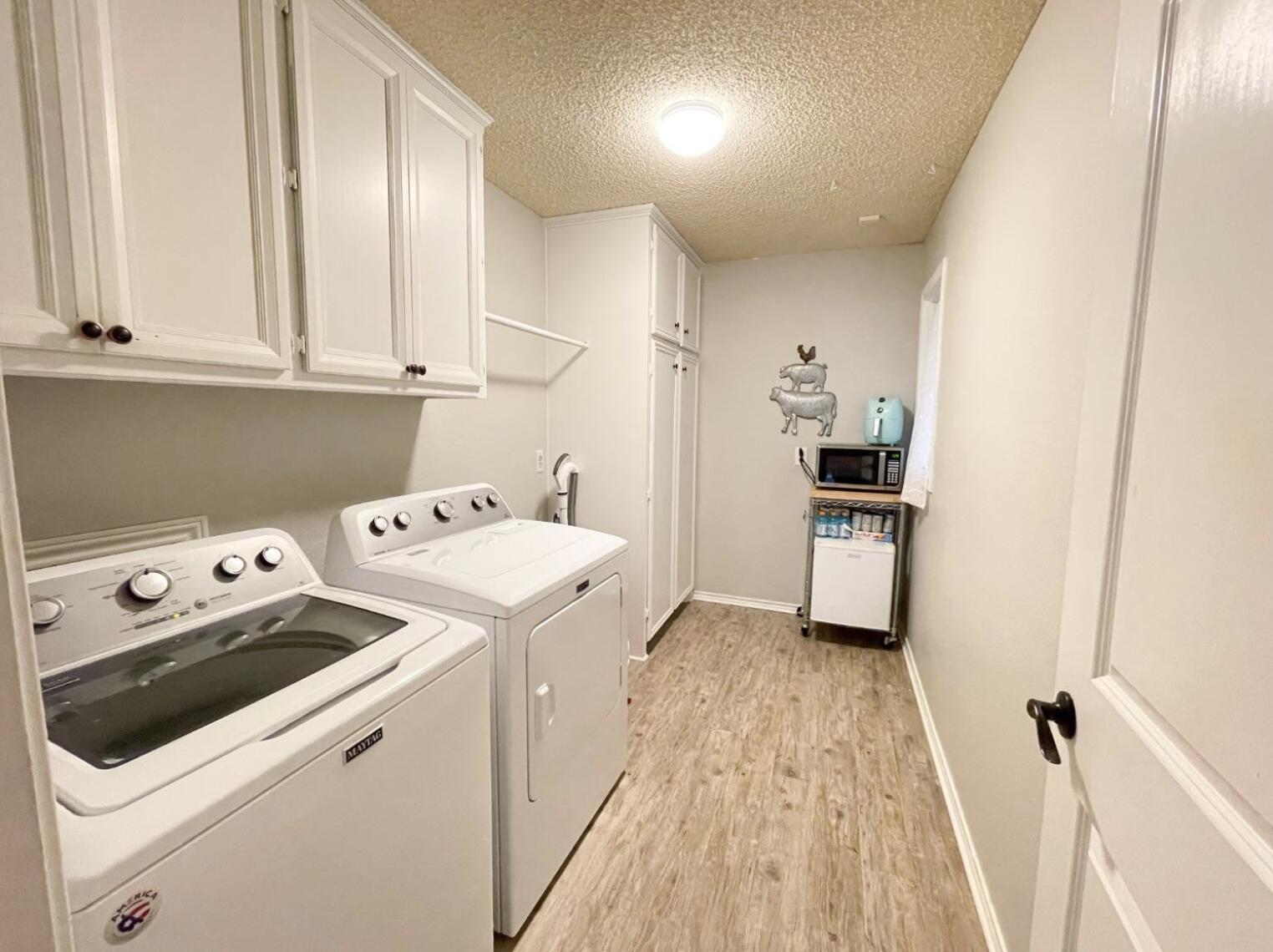5413 83rd Street Lubbock, TX 79424 - Photo 16 of 21 a view of utility room with washer and dryer