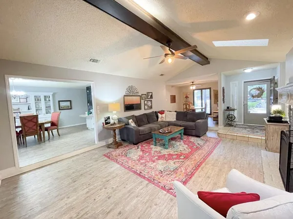 a living room with furniture or couch and a dining table