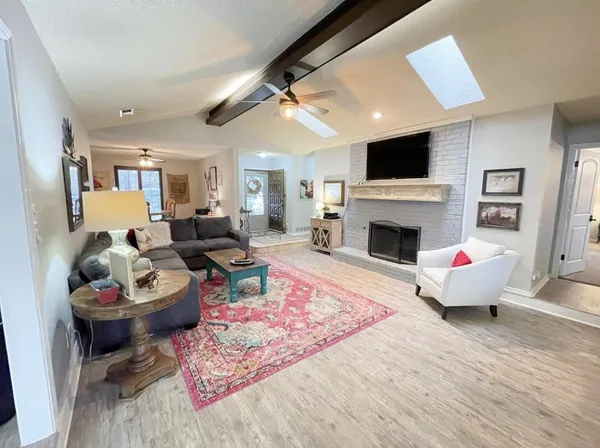 a living room with furniture fireplace and flat screen tv