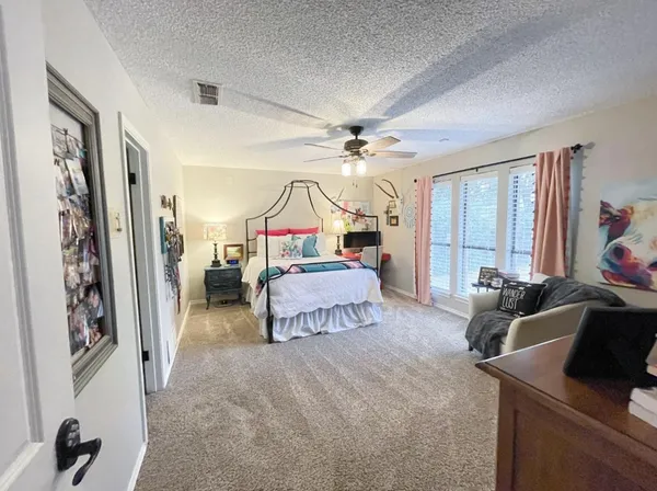 a bedroom with furniture and a chandelier