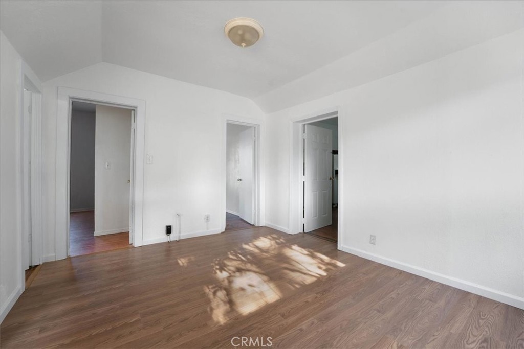 818 6th Street Corning, CA 96021 - Photo 11 of 36 an empty room with wooden floor and windows