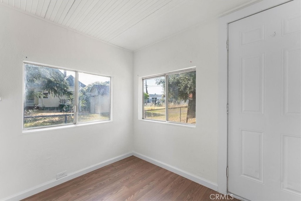 818 6th Street Corning, CA 96021 - Photo 13 of 36 a view of an empty room with a window and wooden floor