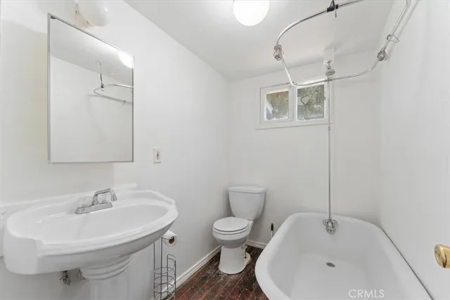 a bathroom with a sink toilet and a mirror