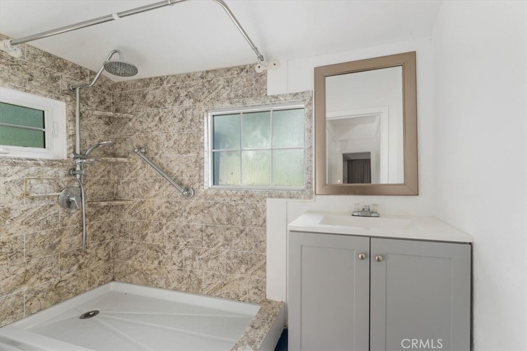 818 6th Street Corning, CA 96021 - Photo 8 of 36 a bathroom with a sink a mirror and a bathtub
