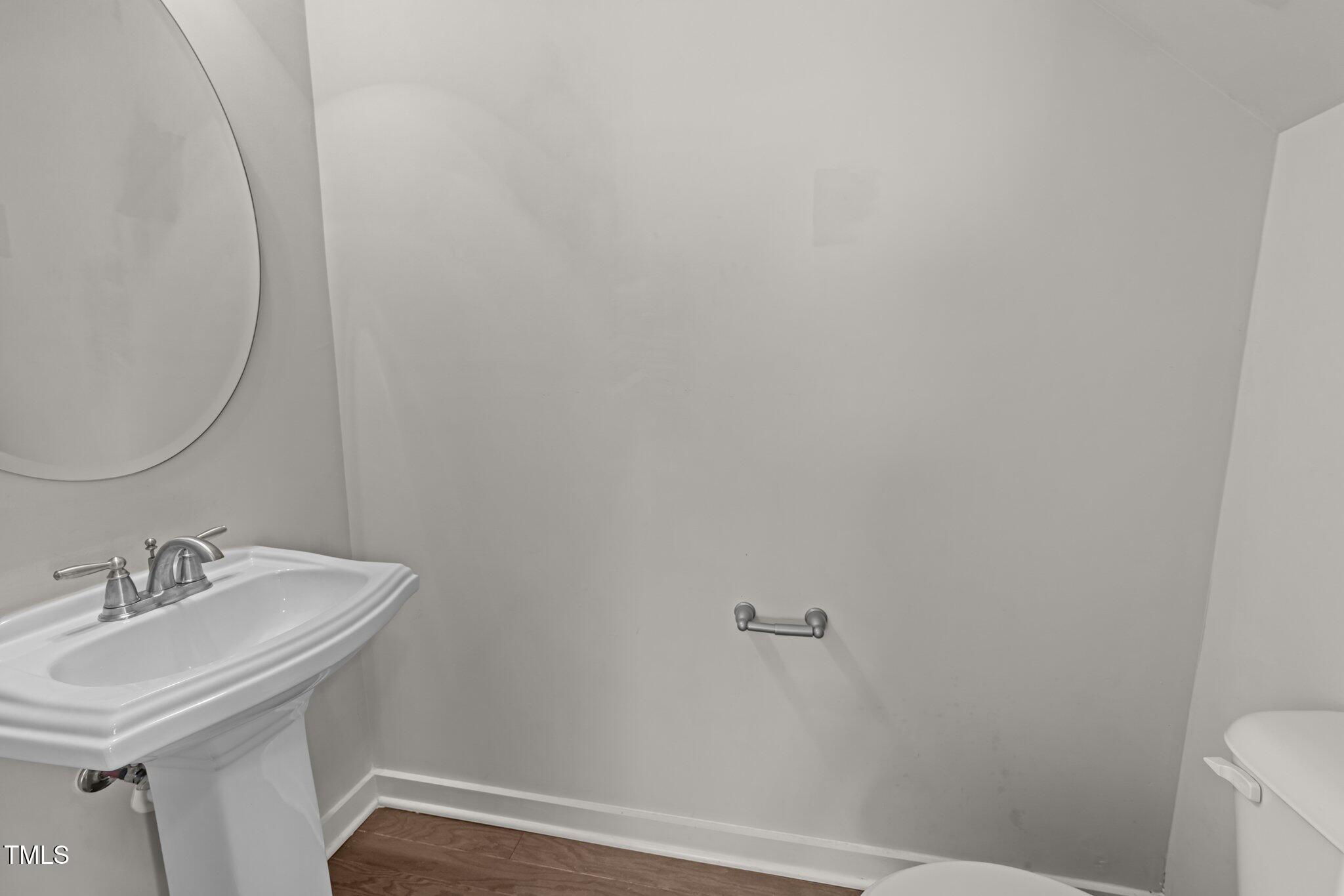 7824 Allscott Way Raleigh, NC 27612 - Photo 11 of 26 a bathroom with a sink and a mirror