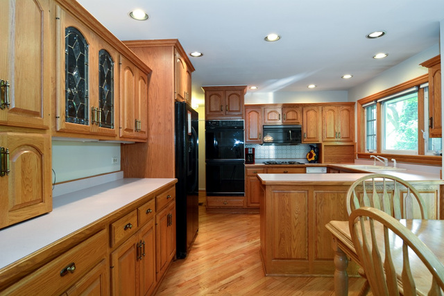2 Red Haw Road Rolling Meadows, IL 60008 - Photo 5 of 10 a kitchen with stainless steel appliances granite countertop a refrigerator a stove and a sink with wooden floor