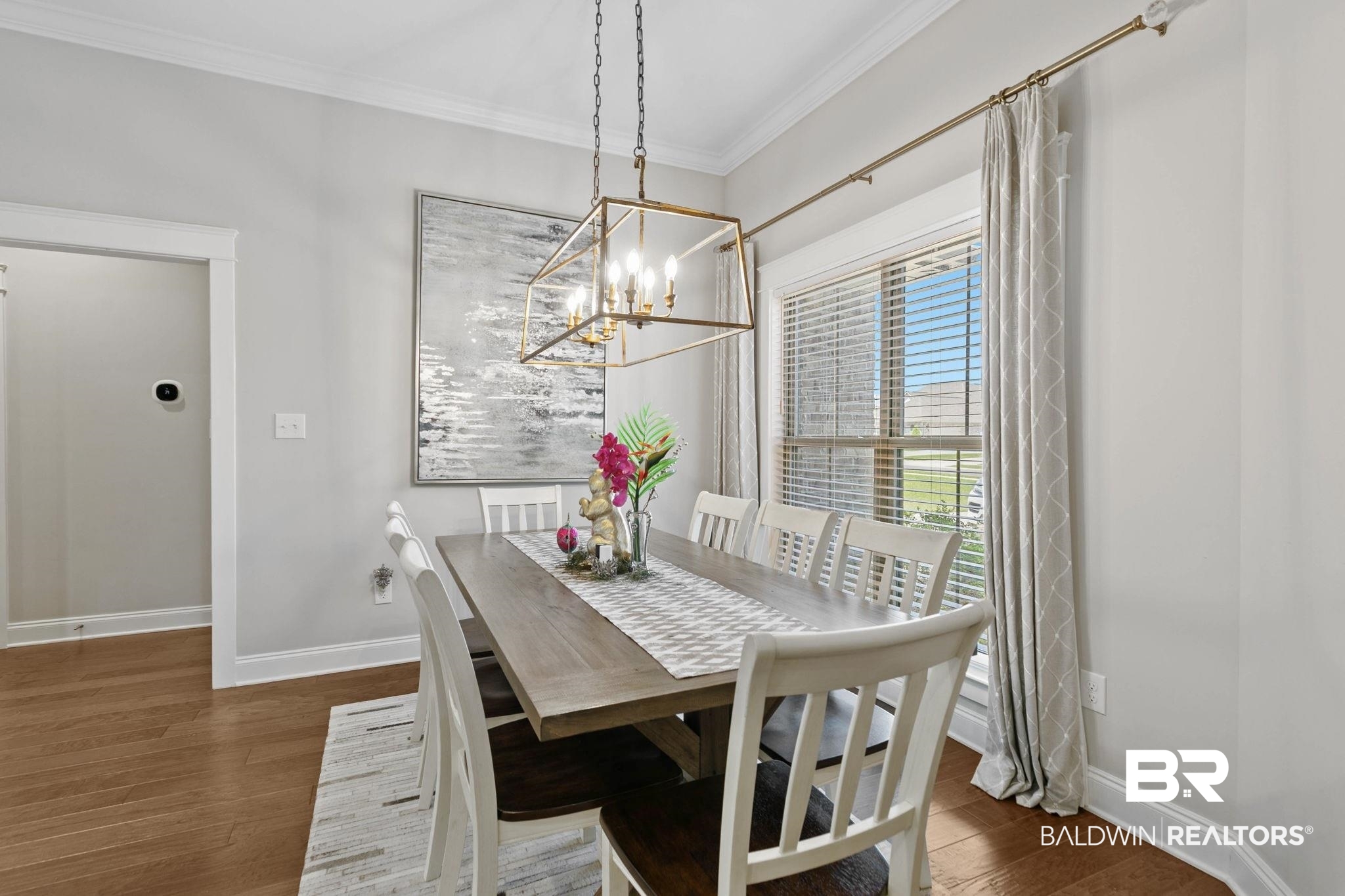 291 Hemlock Drive Fairhope, AL 36532 - Photo 23 of 65 Dining area featuring crown molding, wood finished floors, and a chandelier