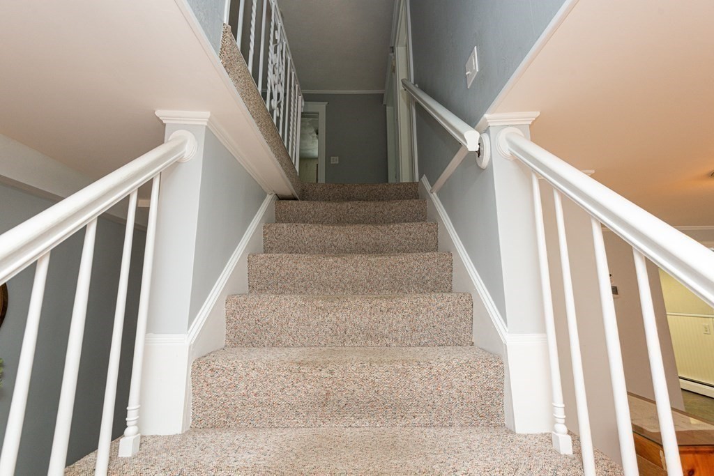 46 Holten Street Peabody, MA 01960 - Photo 12 of 41 a view of staircase with wooden floor and white walls