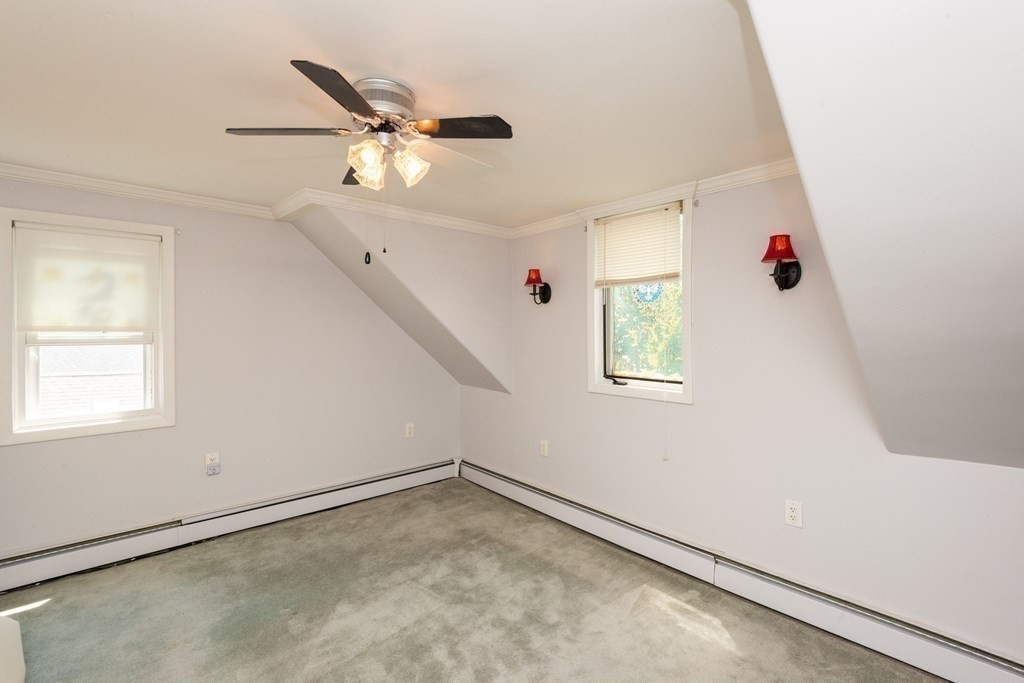 46 Holten Street Peabody, MA 01960 - Photo 14 of 41 an empty room with ceiling fan and window