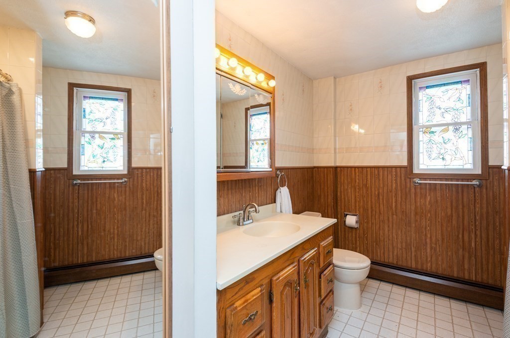 46 Holten Street Peabody, MA 01960 - Photo 25 of 41 a bathroom with a sink a toilet and window