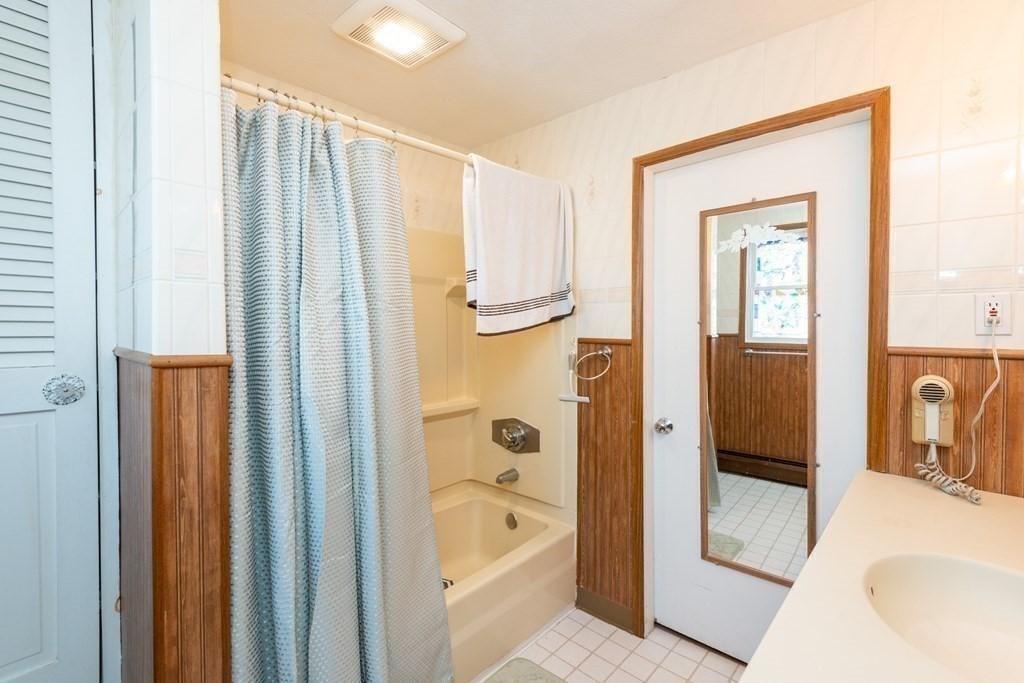 46 Holten Street Peabody, MA 01960 - Photo 26 of 41 a bathroom with a tub shower and sink