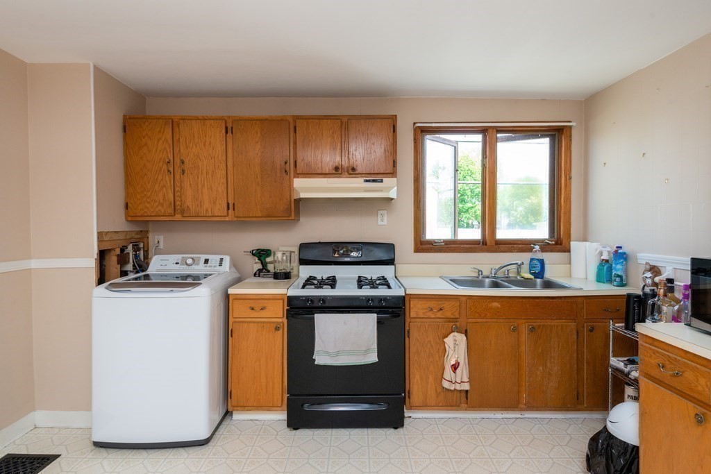 46 Holten Street Peabody, MA 01960 - Photo 29 of 41 a kitchen with a stove and a refrigerator