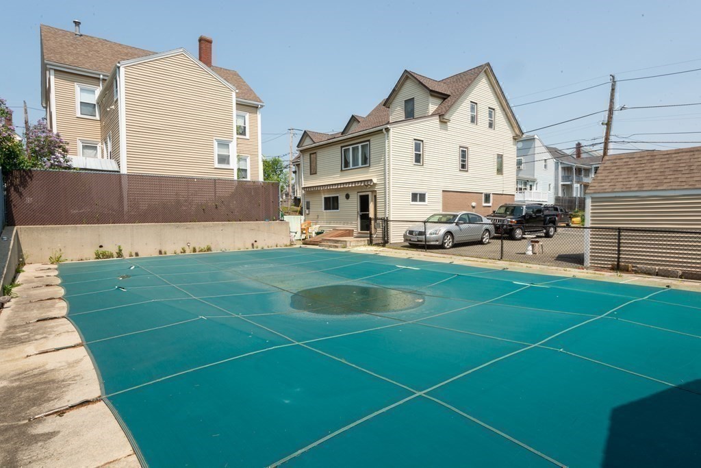46 Holten Street Peabody, MA 01960 - Photo 41 of 41 a view of a white house with a big yard and large trees