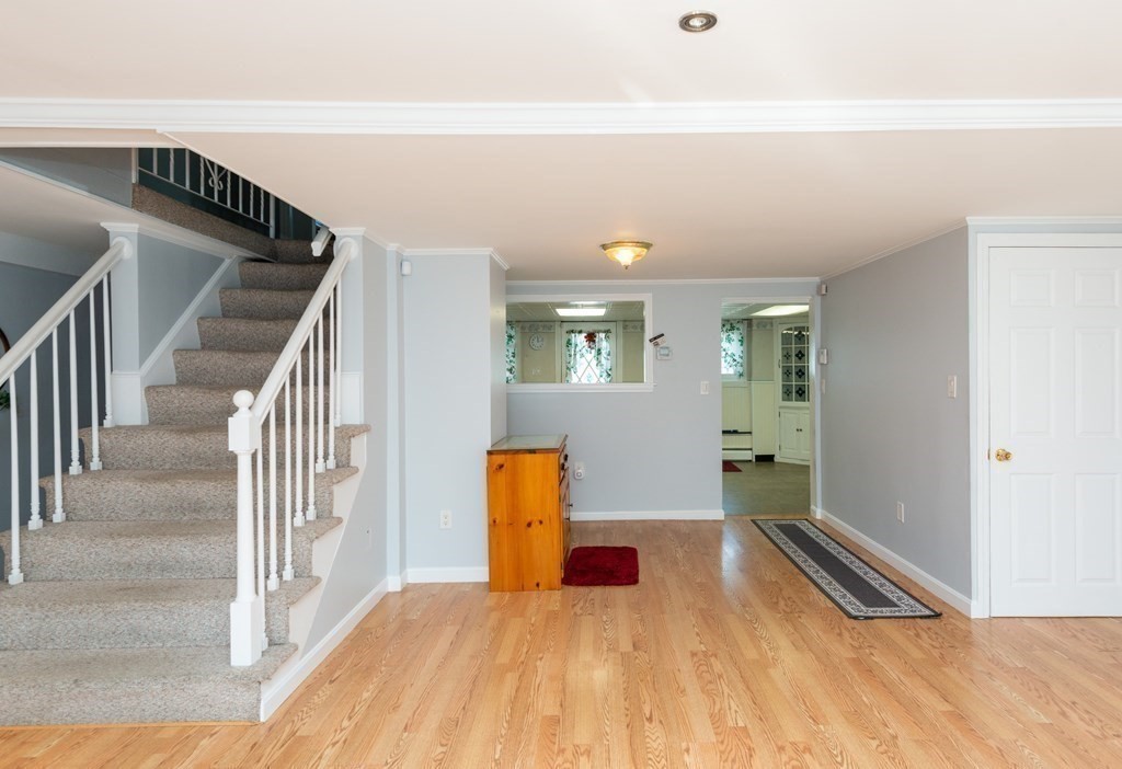 46 Holten Street Peabody, MA 01960 - Photo 5 of 41 a view of a bedroom with wooden floor and stairs