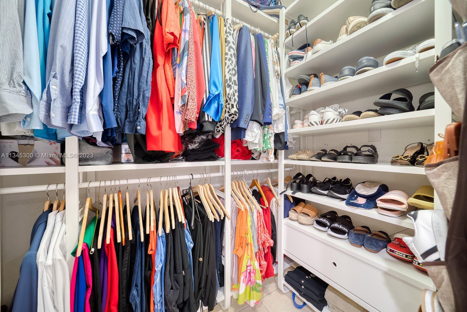 1635 Southeast 20th Place Homestead, FL 33035 - Photo 14 of 28 a view of walk in closet with clothes and shoes