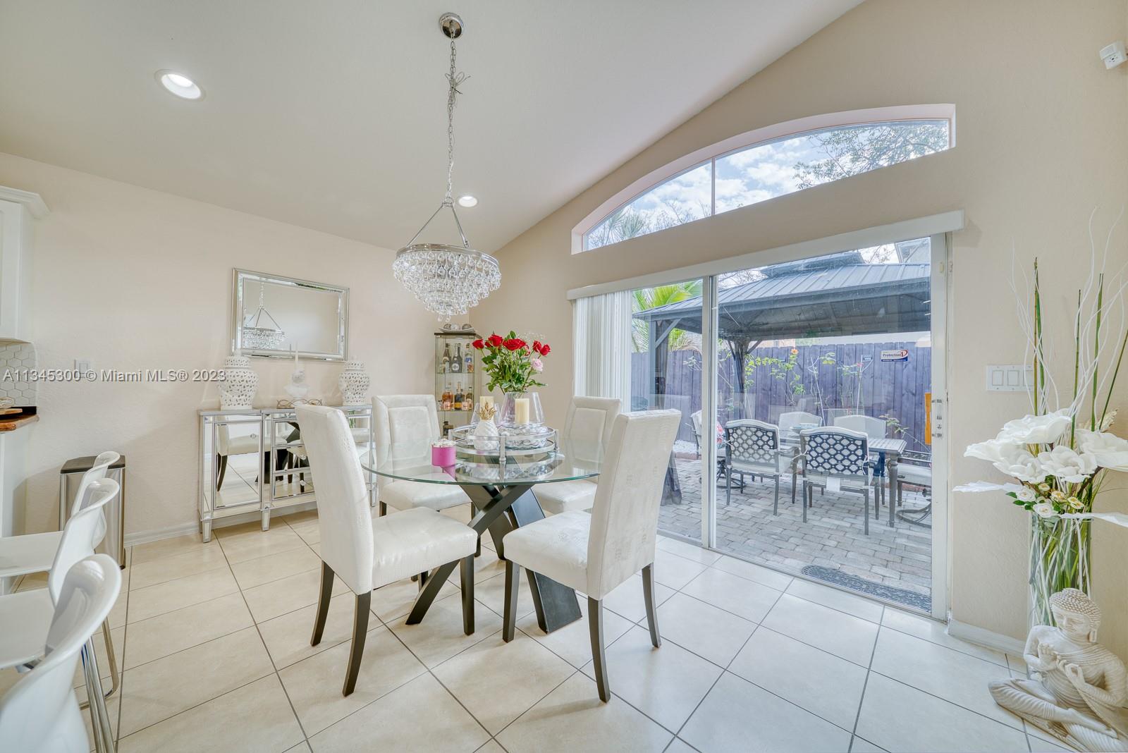 1635 Southeast 20th Place Homestead, FL 33035 - Photo 16 of 28 a dining room with furniture and a chandelier